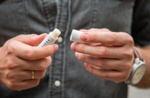 SVEDA-tallow-lip-balm-mens-skincare-product-in-hands